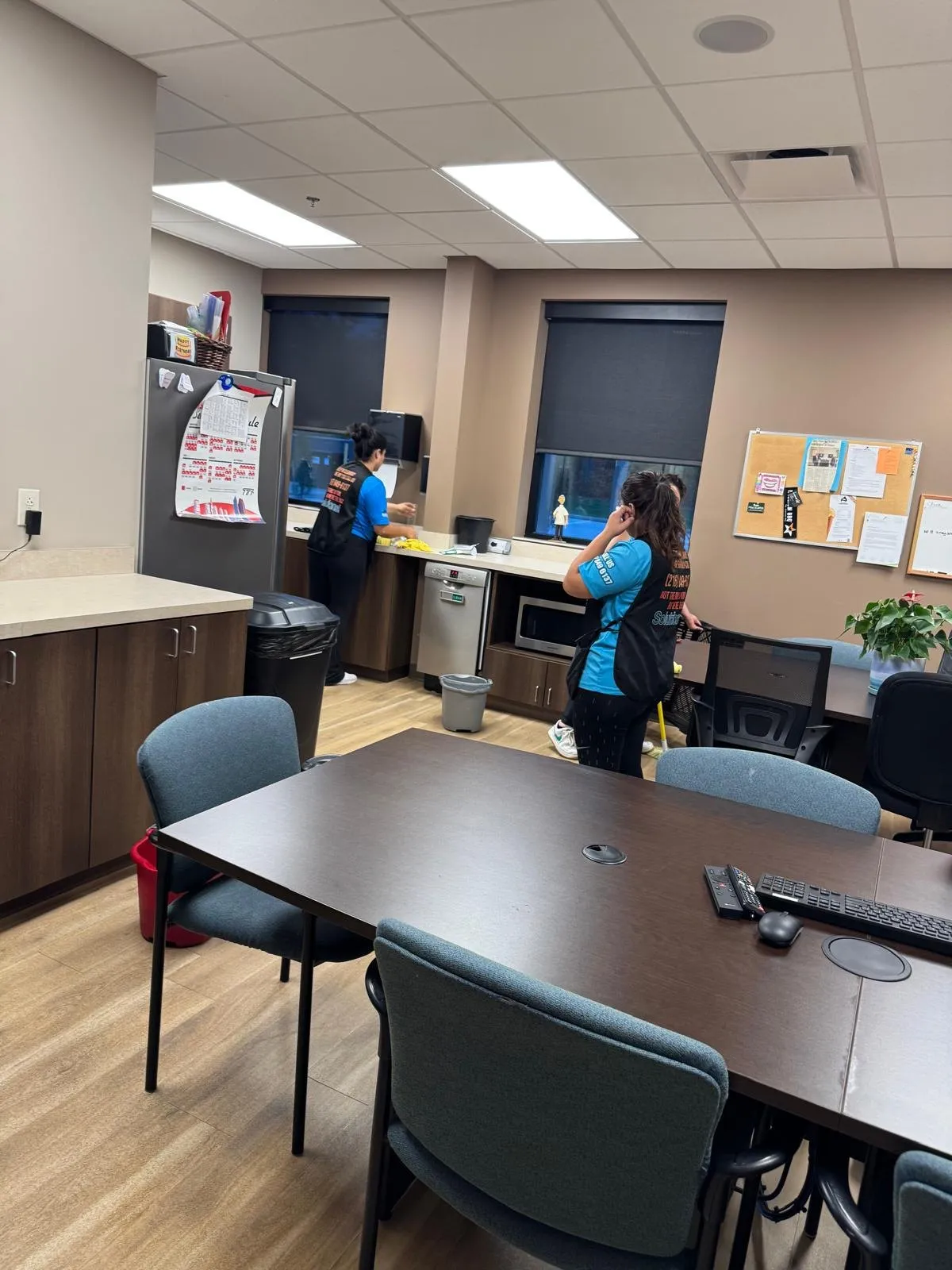 Solutions Cleaning team cleaning the counters and floor of a dental office staff break room
