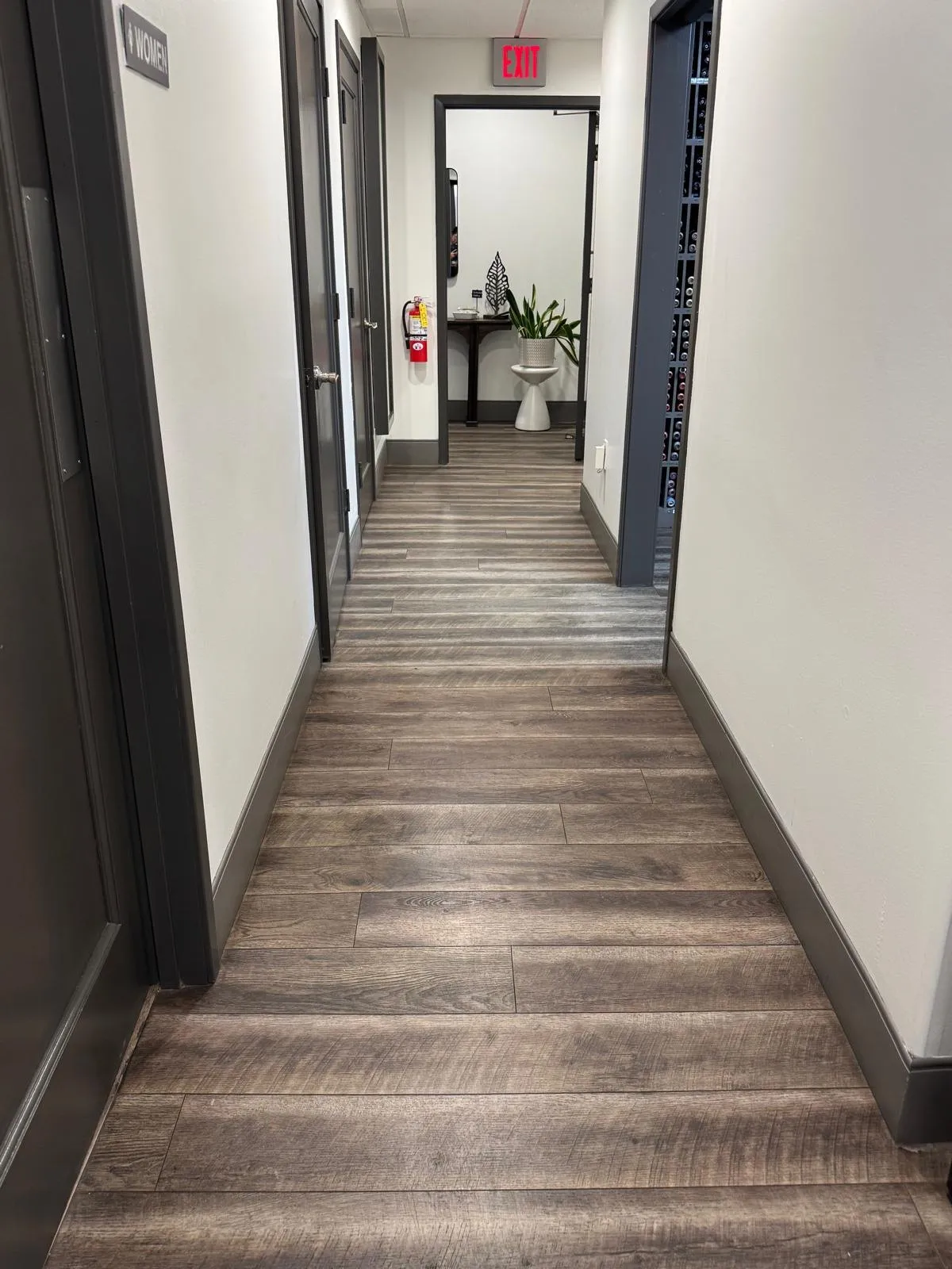 Clean wood-look floor in a salon hallway