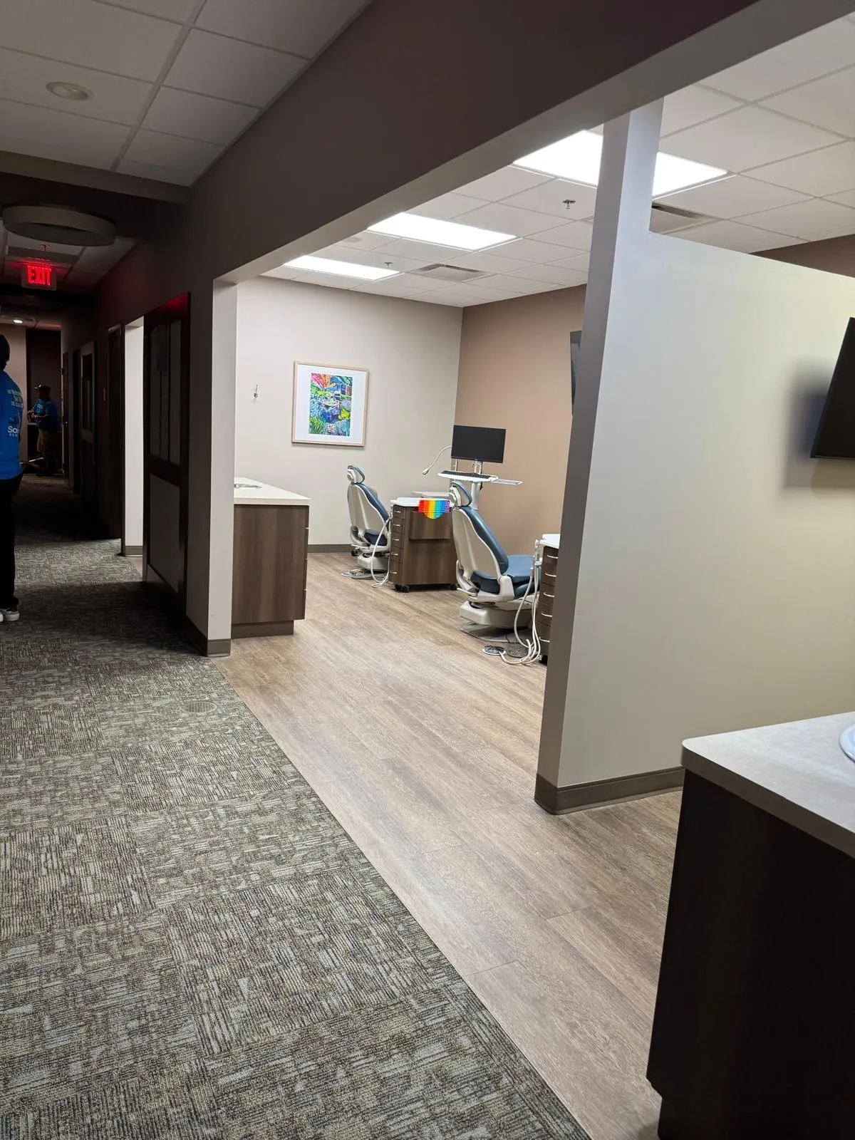 Clean dental office hallway and operatory with patient chairs
