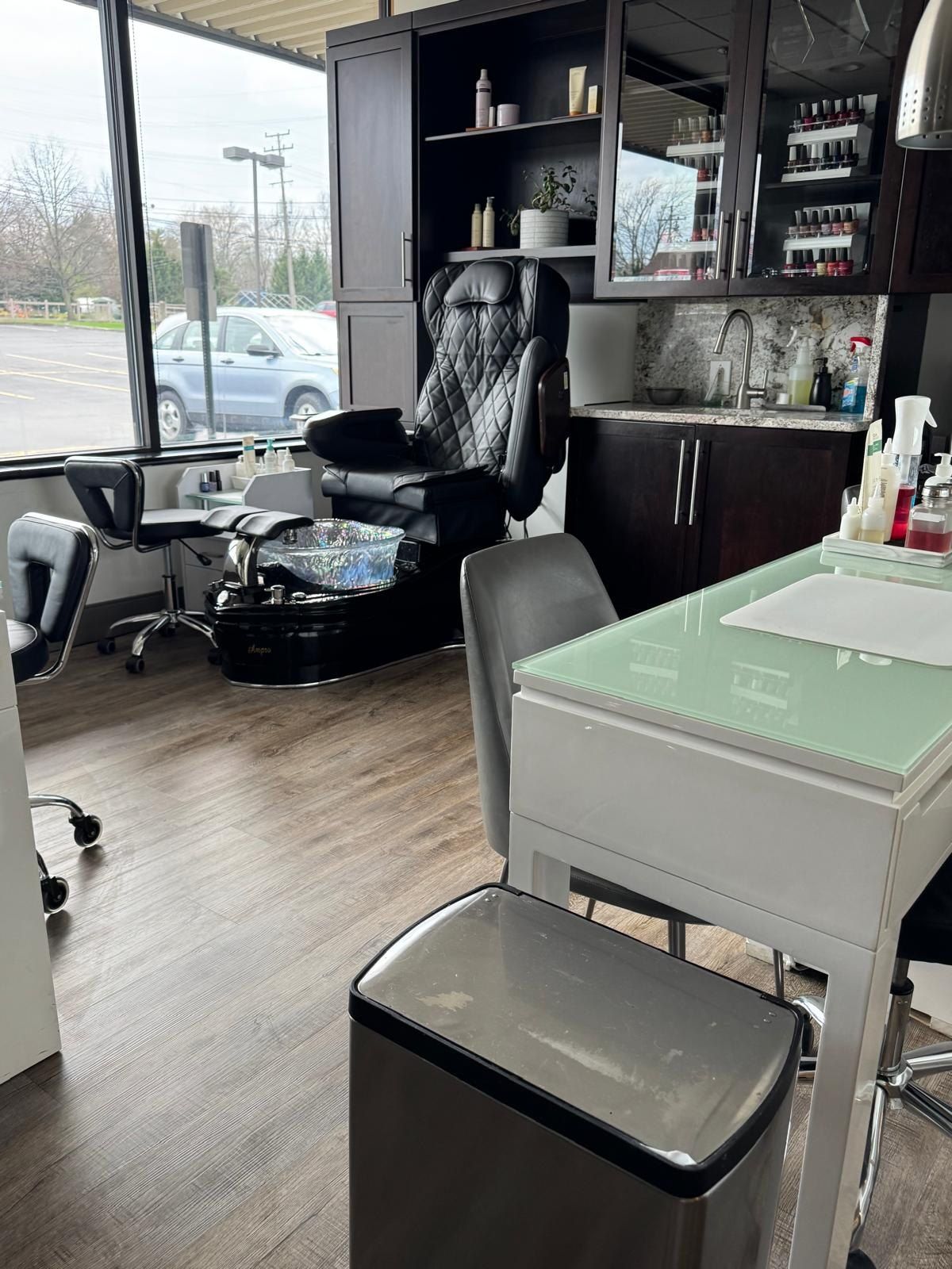 Clean pedicure chair and manicure station in a bright nail salon